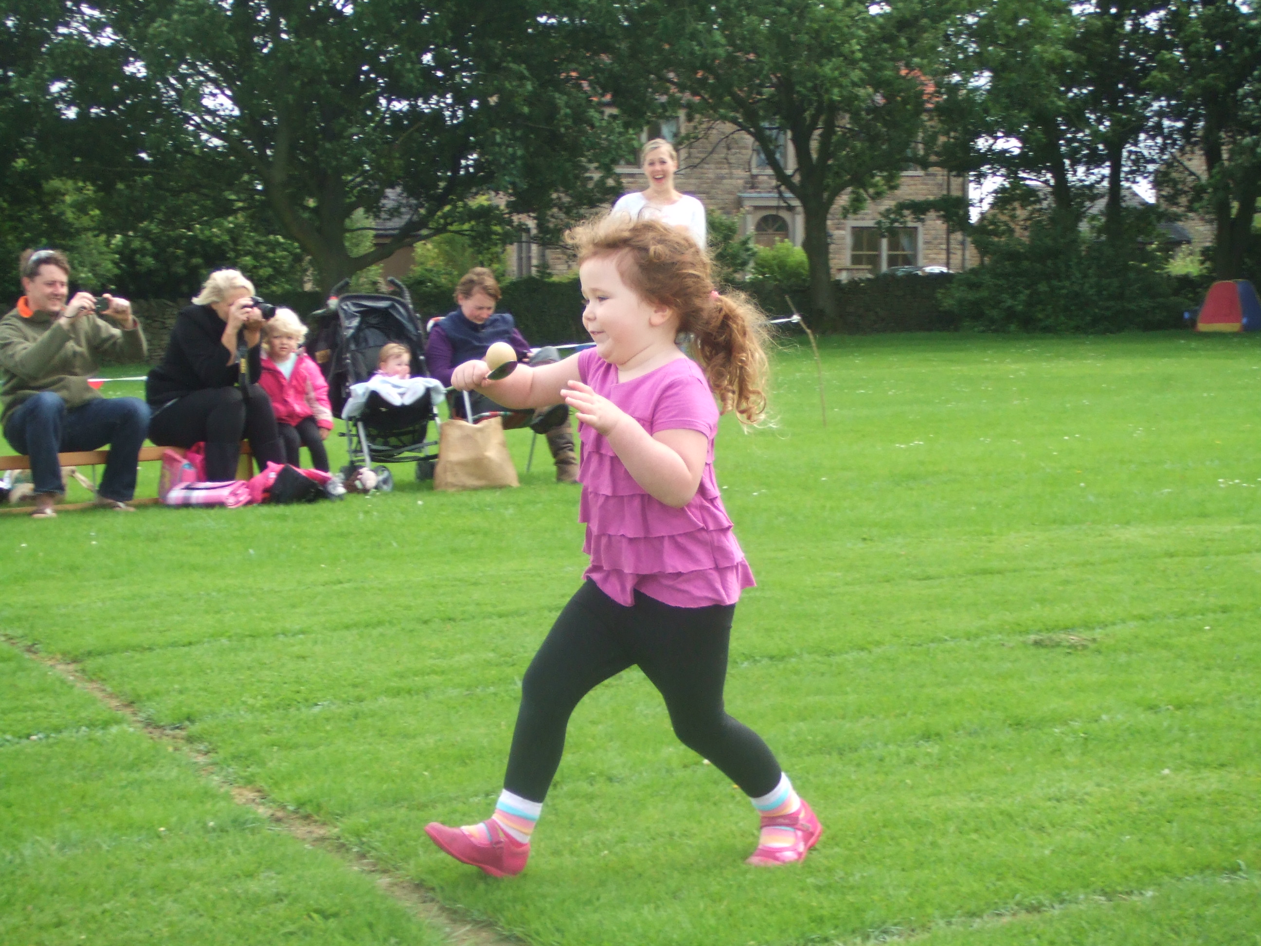 Child running egg and spoon race
