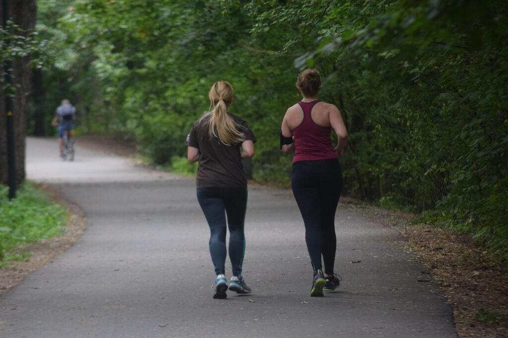 Two women running in a park