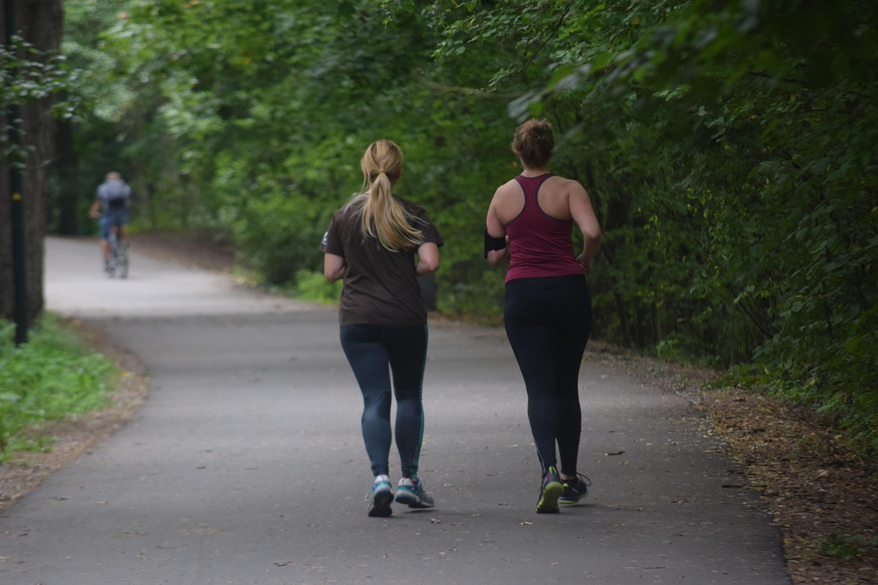 Two women running in a park